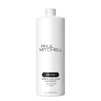 A tall white bottle of Paul Mitchell Freeze and Shine Hairspray with Firm Hold, shown on a clean white background.