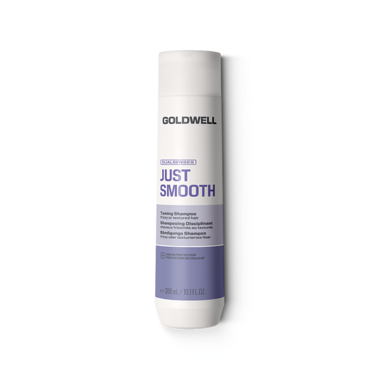 A bottle of Goldwell Just Smooth Taming Shine shampoo on a solid white background.