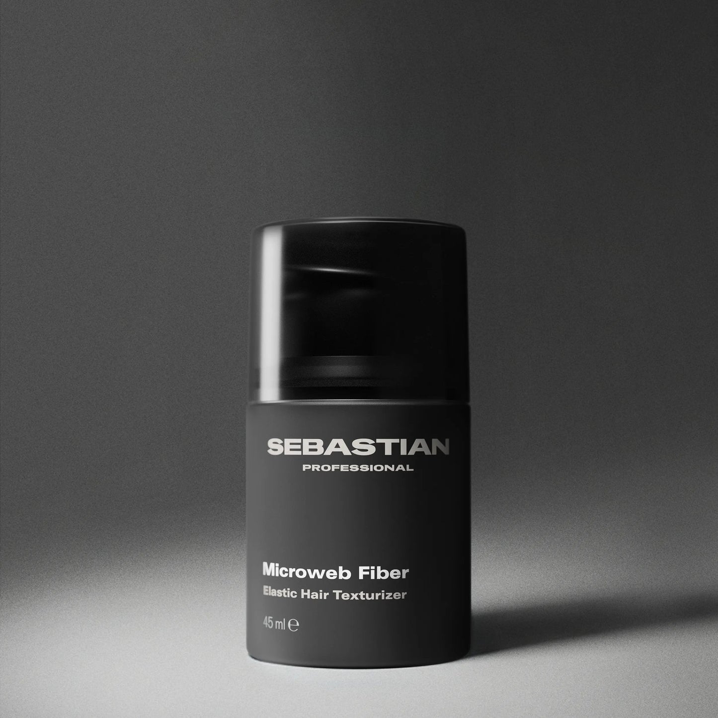Black container of Sebastian Professional Microweb Fiber on a gray background